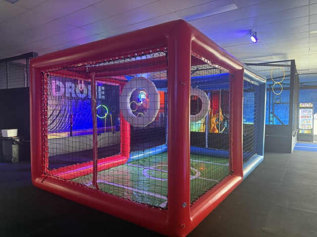 Drone soccer arena showing hoop goal and netted walls